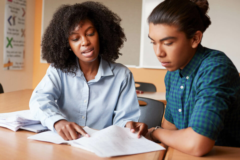 teacher helping student with applications